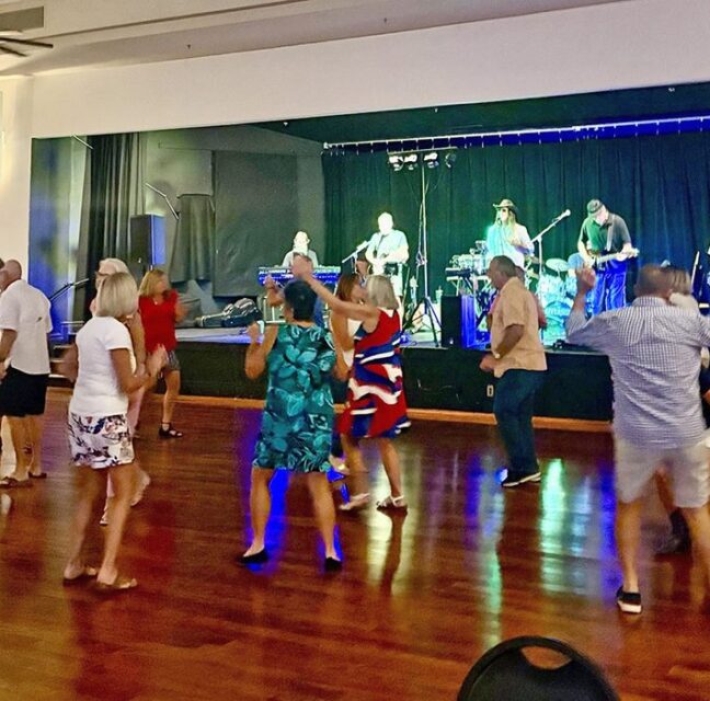 Herons Glen residents dancing to a live band in the ballroom