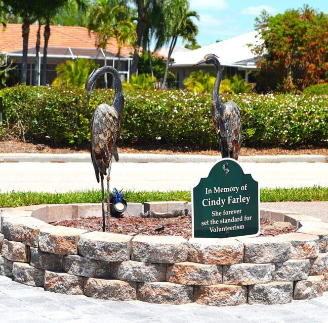 Herons Glen memorial park with two heron sculptures on a stone base