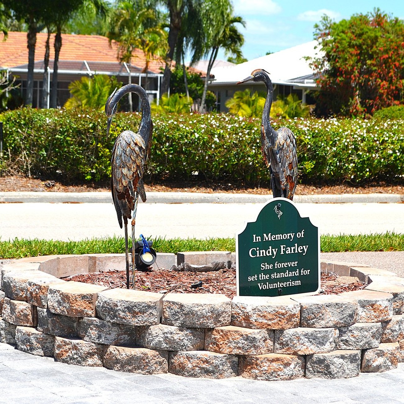 Herons Glen memorial park with two heron sculptures on a stone base